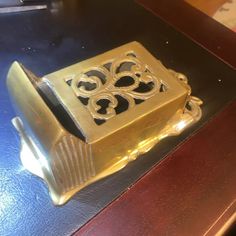 a gold box sitting on top of a wooden table