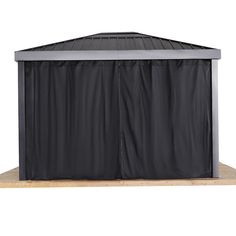 a black gazebo on top of a wooden platform with the door open and curtains closed