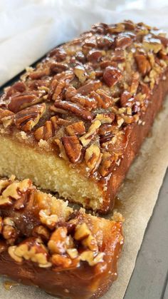 a loaf of bread with pecans on top