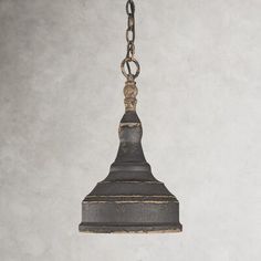 an old metal light hanging from a chain