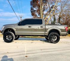 a silver truck parked on the side of a road