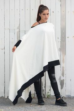 The asymmetric shape adds movement to the piece while the monochrome color makes this a current and trendy buy.  The long sleeves are half white, half black. There is black lining on the top and bottom of the blouse. Oversized Tunic Dress, Asymmetric Shirt, White Cotton Blouse, Loose Tunic, Asymmetric Top, Blouse Cotton, Monochrome Color, Oversized Tunic, White Tunic