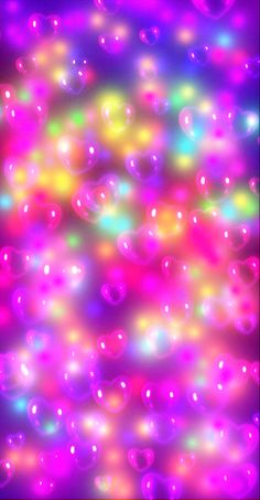 colorful bubbles floating in the air on a black background with pink, yellow and green colors