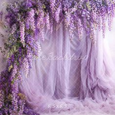 purple flowers are growing over the sheer curtains