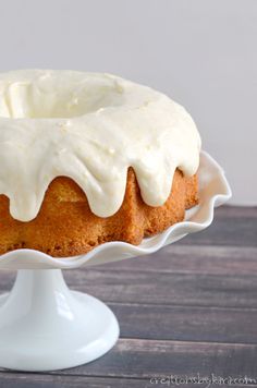 a bundt cake with white icing on a plate