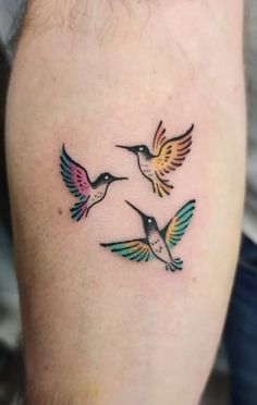 three colorful hummingbirds on the left thigh