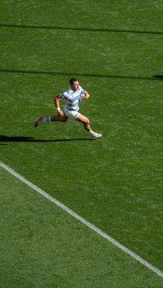 a man running across a lush green field