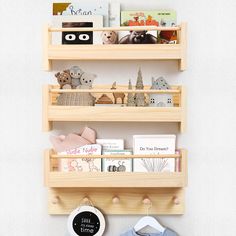 two wooden shelves with books and toys on them, one shelf is holding children's books