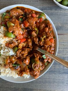 a white bowl filled with meat and rice