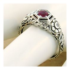 Vintage Estate Natural Ruby Filigree Ring. Cubic Zirconia Accent Stones. Intricate Floral Details. 925 Solid Sterling Silver. The Top Of The Ring Measures Just Over 1/4 Inch In Length. Set With One 4 mm Round Faceted Natural Ruby With 2 Cubic Zirconia Side Stones. Stamped 925. Excellent Condition/Like New. Silver Ruby Ring With Center Stone In Sterling Silver, Heirloom Sterling Silver Engraved Ring With Gemstone, Silver Ruby Ring With Center Stone, Classic Round Gemstone Flower Ring, Classic Sterling Silver Engraved Ring With Gemstone, Classic Silver Ruby Ring For Anniversary, Classic Adjustable Flower Ring For Anniversary, Engraved Ruby Ring For Anniversary, Vintage Cubic Zirconia Ring Stamped 925