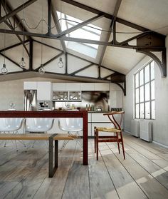 an open kitchen and dining area with wooden floors, white walls and ceilinging is shown