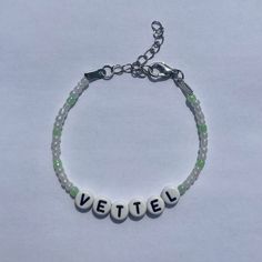 a beaded bracelet with the word vettiel written on it in white letters