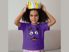 Introducing our fun and quirky Grimace Face Kids Tee! 🎉👕 If your little ones love the iconic Grimace character and have a taste for humor, this shirt is a must-have!  Featuring a unique and amusing design with Grimace's hilarious expressions, it's sure to bring a smile to their faces and everyone around them. 🤣🍔 Made with soft and comfortable materials, this tee is perfect for everyday adventures, playdates, or birthday parties. Whether they're fans of the Grimace Shake, or simply looking to Funny Grimace, Grimace Shake, Kids Wardrobe, Everyday Adventures, Face Design, Iconic Characters, Kid Tees, Funny Tees, Kids' Fashion