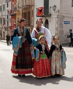 three women and two children are dressed in traditional clothing