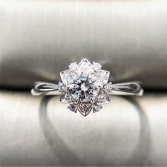 a white gold ring with an oval cut diamond in the center