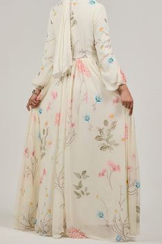 Step into a world of elegance with our Enchanting Blossom Chiffon Maxi Dress. This dress is adorned with a delicate floral print that adds a touch of grace and femininity. The long sleeves and flowing silhouette offer modest coverage, making it perfect for any occasion. Crafted from luxurious chiffon and lined with polymix fabric, this maxi dress ensures comfort and style. The subtle floral design in soft hues of pink, blue, and green creates a harmonious blend, enhancing the dress's ethereal be Feminine Cream Floral Print Maxi Dress, Feminine Cream Maxi Dress With Floral Print, Bohemian Floral Print Dress In Georgette, Bohemian Floral Print Georgette Dress, Bohemian Georgette Dress With Floral Print, Beige Floral Print Chiffon Dress, Floral Print Long Sleeve Georgette Maxi Dress, Long Sleeve Georgette Maxi Dress With Floral Print, Beige Chiffon Maxi Dress For Garden Party