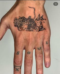 a man's hand with a tattoo on it that has an image of a motorcycle