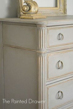 an old dresser has been painted white and gold