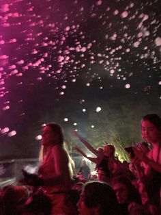 a group of people standing next to each other at a concert