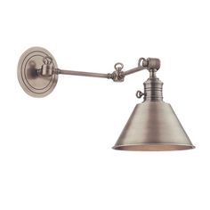 an old fashioned wall light with a metal shade