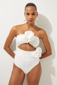 Welcome The Sun With A Swimming Costume That Will Turn Heads, Featuring A Three Dimensional Corsage Accent On The Bust And Hip, And A Statement Cut Out Design In The Front And Back. Style This Piece With Strappy Sandals And A Beach Cover Up For A Holiday Look That Can Be Reworn Time And Time Again. Rosette Cut Out Detail Swimsuit Flattering Halter Neckline Unique, Three Dimensional Flower Accent Statement Cut Out Design Tie And Clasp Fastening In Back One Piece Swimsuit Outfit Cover Up, Bali Outfits, Bride Swimsuit, Bridal Swimsuit, Hen Do Outfits, Petite Wedding Guest Dresses, Workwear Capsule Wardrobe, Flower Swimsuit, Women Swimming