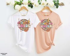 two t - shirts with the words happy birthday written on them and flowers in the background