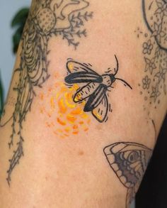 a close up of a person's arm with tattoos on it and a butterfly