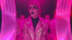 a woman with black makeup and pink lights