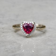 Beautifull Heart Ruby Ring - 14k Gold Diamond Ruby Ring - July Birthstone Ring - Holiday Gift Ring - Fashion Ruby Ring - Dainty Ruby Ring GEMSTONE DETAILS : ✦ Gemstone : Natural Ruby ✦ Gemstone Size : 6 mm ✦ Gemstone Shape : Heart ✦ Number of Gemstones : 1 ✦ Gemstone Weight : 1.80 Carat ✦ Gemstone Grade : AAA DIAMOND DETAILS : ✦ Diamond Type : Natural ✦ Diamond Size : 1.5 MM ✦ Diamond Color : G-H ✦ Diamond Clarity : Slightly included ✦ Diamond Cut : Excellent ✦ Diamond Weight : 0.40 Carat METAL DETAILS : ✦ Metal : 14K/18K/22K Gold ✦ Metal Color : Yellow / White / Rose Gold ✦ Setting : Bezal Setting ✦ Box : Yes SHIPPING DETAILS : ✦ Production time : 3-4 days ✦ Delivery time : 7-8 days ✦ Expedited shipping : Available ✦ Expedited shipping service : UPS ✦ Expedited shipping time : 5 days ✦ Ex Real Emerald Necklace, Dainty Ruby Ring, Mens Emerald Rings, Rubin Ring, July Birthstone Ring, Rainbow Sapphires, Ring Fashion, Emerald Pendant, Emerald Earrings