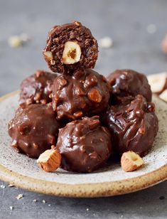 a plate filled with chocolate covered cookies and nuts