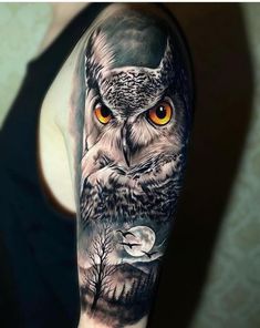 an owl with orange eyes is shown on the upper half of this arm tattoo design