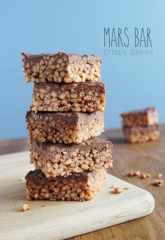 three bars stacked on top of each other with chocolate frosting and nuts in the middle