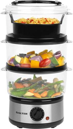 three glass food containers stacked on top of each other with food in the bottom tier