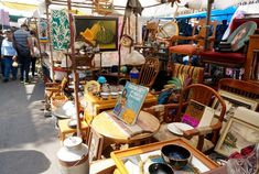 an outdoor flea market with chairs and tables