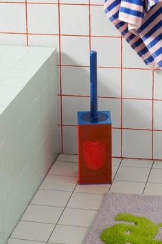 a bathroom with blue and red accessories on the floor