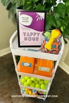 the happy hour sign is on top of a shelf filled with candy and candies