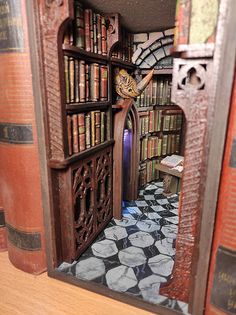 an open book case with books on it and a clock in the doorway to another room