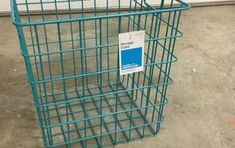 a blue wire basket with a sign on it that says storage cubes in front of a door