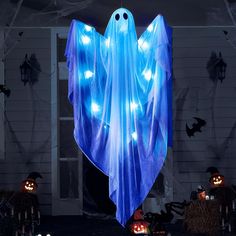 an outdoor halloween decoration with lights and ghost figures