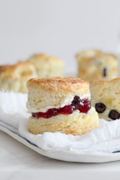 scones with blueberries and cream filling on a white plate