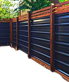 a wooden fence with metal slats on it