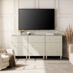 a large flat screen tv mounted to the side of a white cabinet in a living room