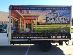 a truck parked in a parking lot with a large advertisement on the back of it