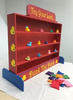 a red book shelf with rubber ducks on it