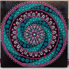 a painting with circles and dots in the center on a black background, it looks like an abstract art work