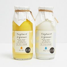 two bottles of yogurt liqueur sitting next to each other