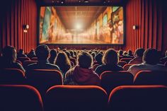 people sitting in an auditorium watching a movie on a large screen with red drapes