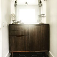 a bathroom with a wooden cabinet and two lights