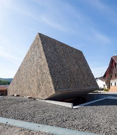 a large stone structure sitting on top of a gravel field