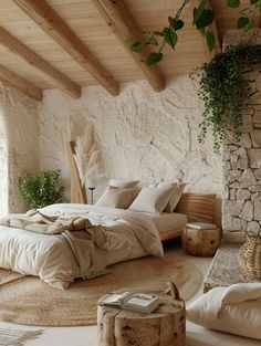 a bedroom with stone walls and flooring has a large bed in the middle, surrounded by natural materials